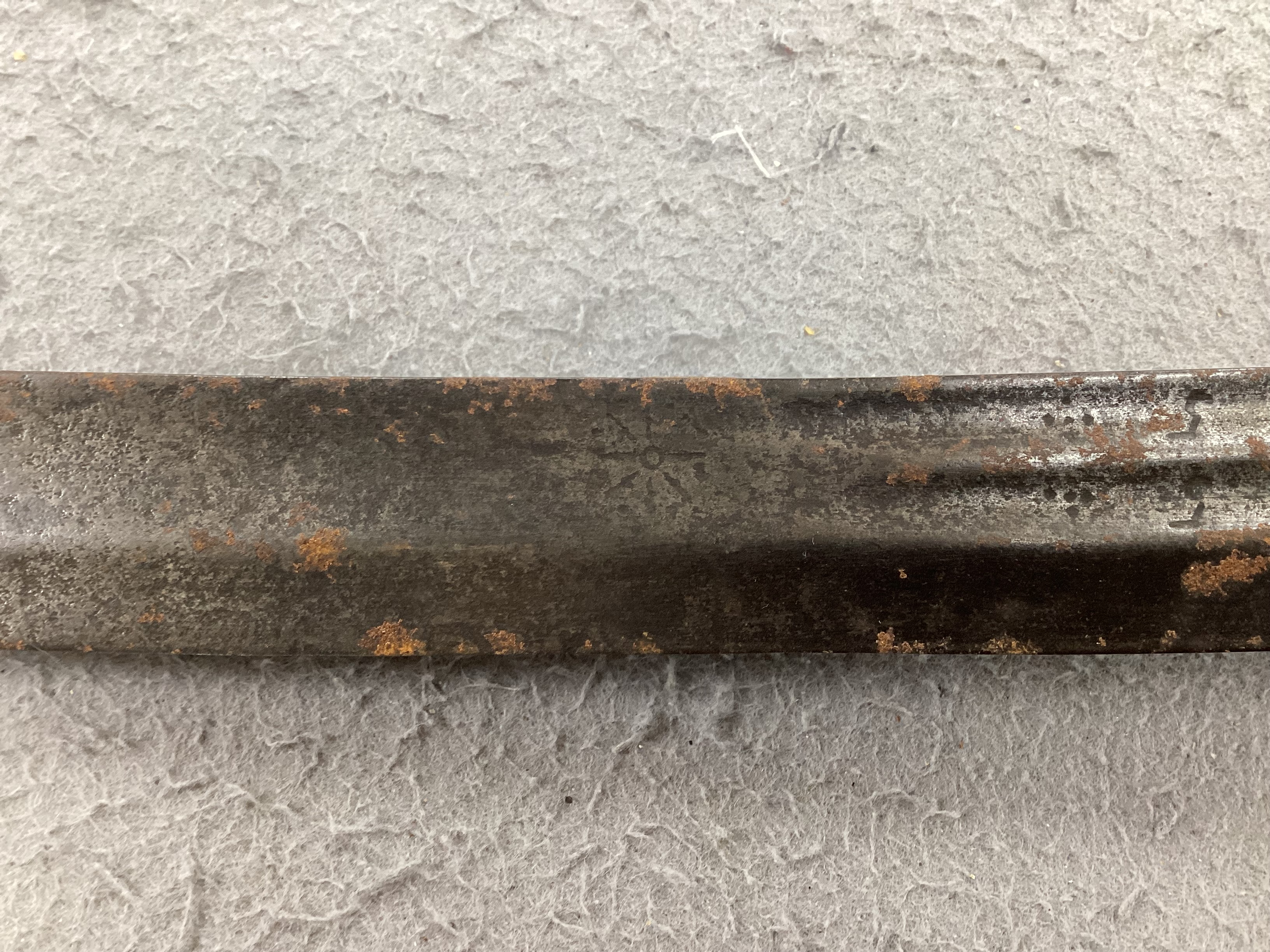 An English hangar, mid 17th century, curved fullered blade engraved with spurious date 1535 and running wolf mark, iron guard slightly reduced and swollen pommel, spirally carved and chequered bone grip, blade 67.5cm